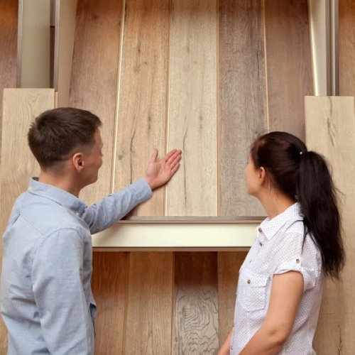 flooring professional showing flooring samples to a potential customer
