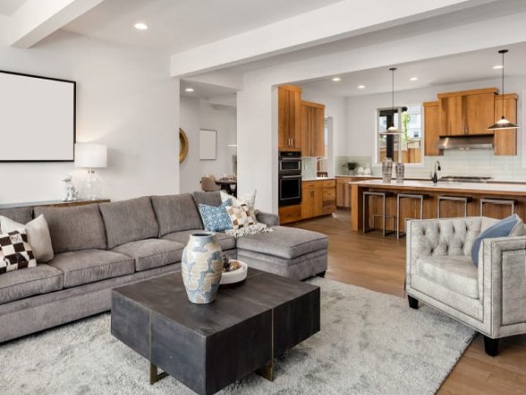 grey carpet in living room with traditional kitchen in the backgroud