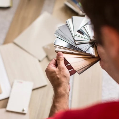 man looking at flooring samples